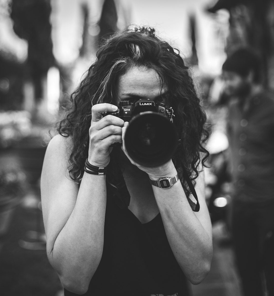 Female journalism trainer with camera background